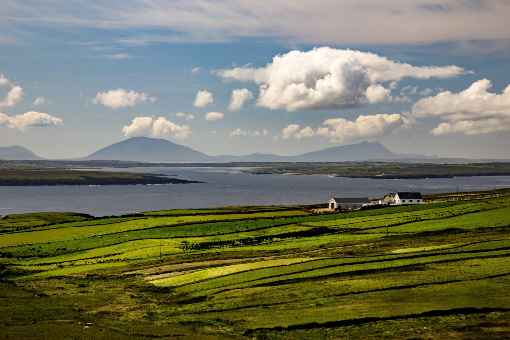 High angle shot of a valley next to the sea in the Near Ballycastle of the County Mayo in Ireland A high angle shot of a valley next to the sea in the Near Ballycastle of the County Mayo in Ireland