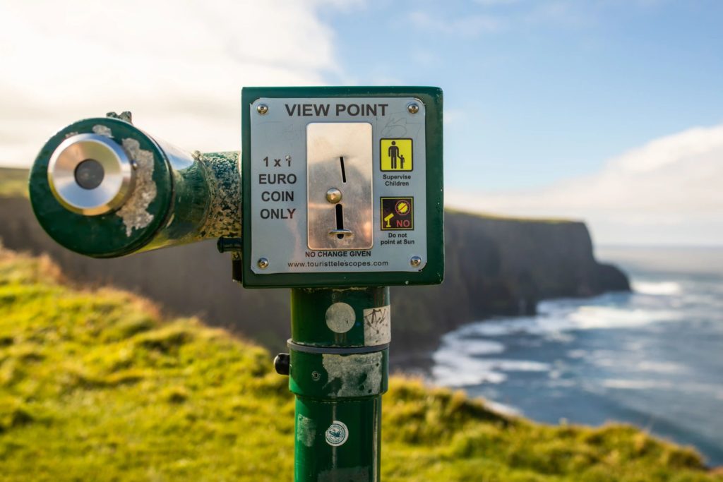 AKphoto (123) Coin-operated telescope overlooking scenic cliffs and ocean in bright daylight, Ireland.