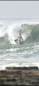 a man riding a wave on a surfboard in the ocean