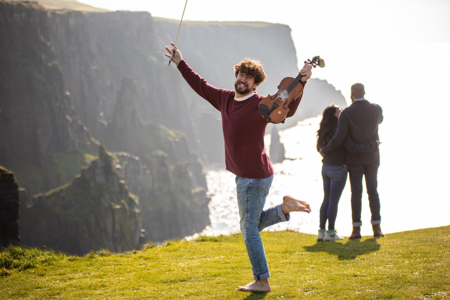 a person flying through the air while holding a kite