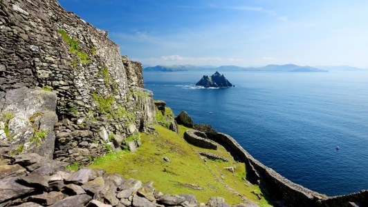 a rocky island in the middle of a body of water